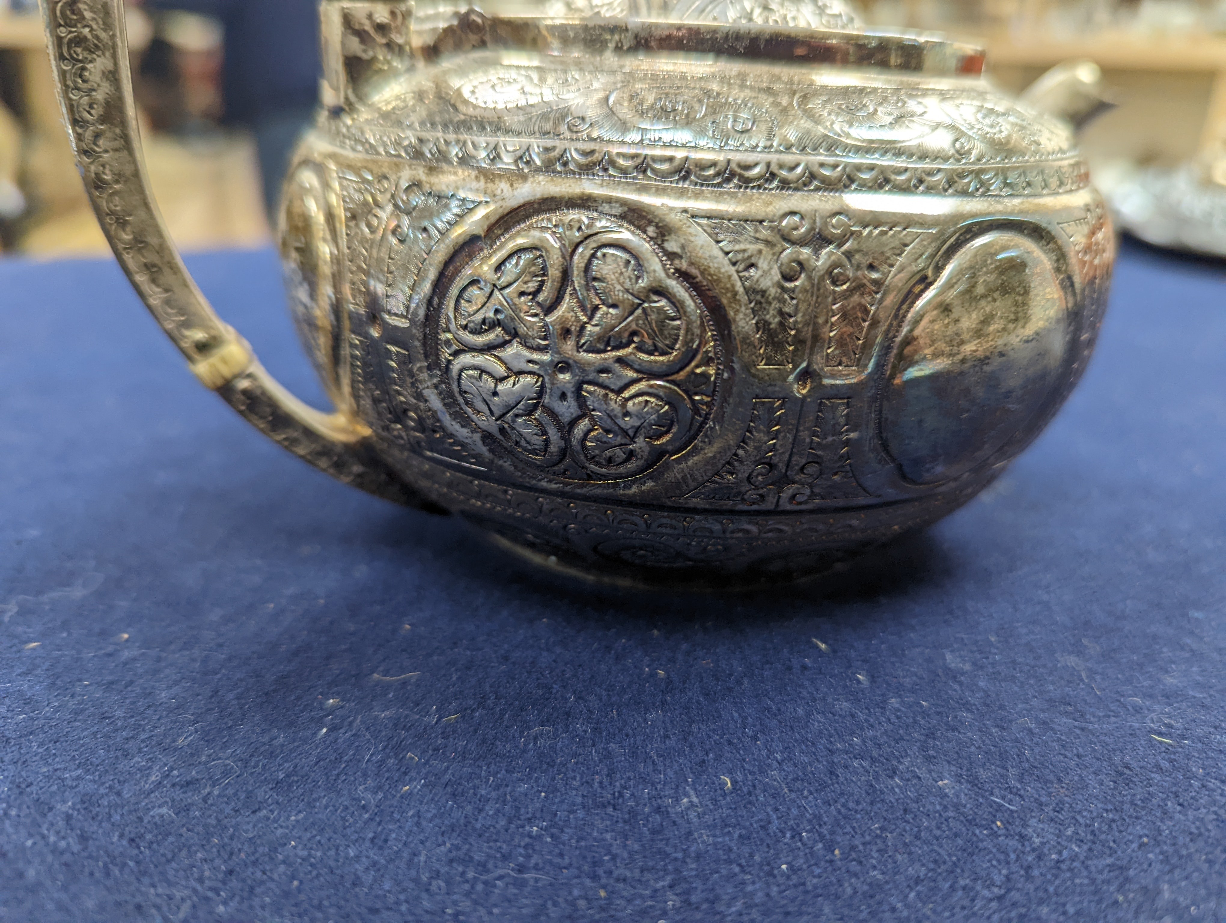 A WMF dish, Islamic white metal mounted photo album and a plated teapot and jug